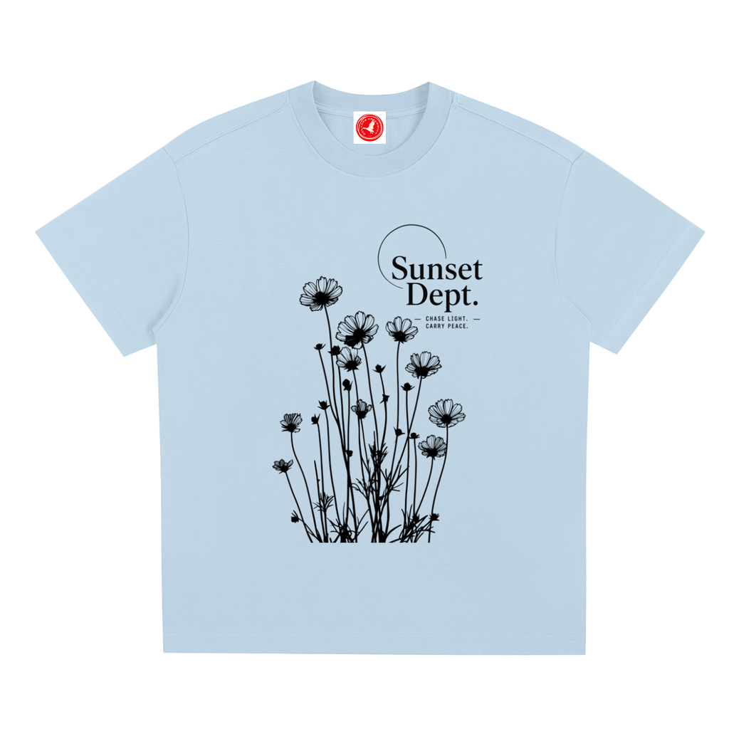 Light Desert-inspired graphic t-shirt featuring artistic landscape artwork blending desert scenery with coastal influences.