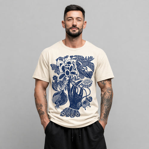 Man wearing a beige Botanical Hand graphic t-shirt featuring botanical hand artwork inspired by vintage floral illustration