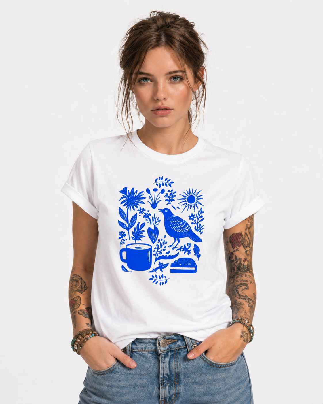 Woman wearing a white Indigo Morning Garden graphic t-shirt featuring botanical artwork inspired by wildflowers, gardens, and natural beauty.