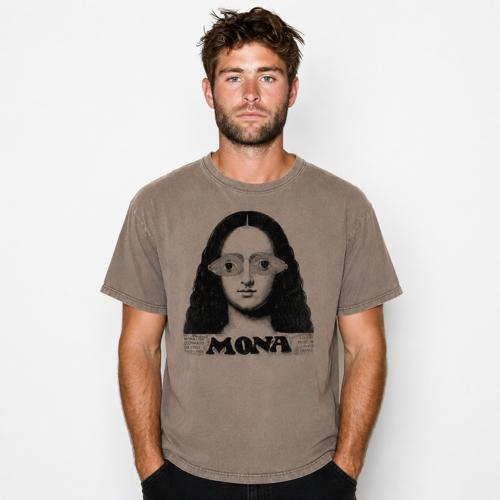 A man wearing a faded brown graphic t-shirt featuring a stylized portrait of Mona Lisa with the word 'MONA' printed below, set against a plain light gray background.