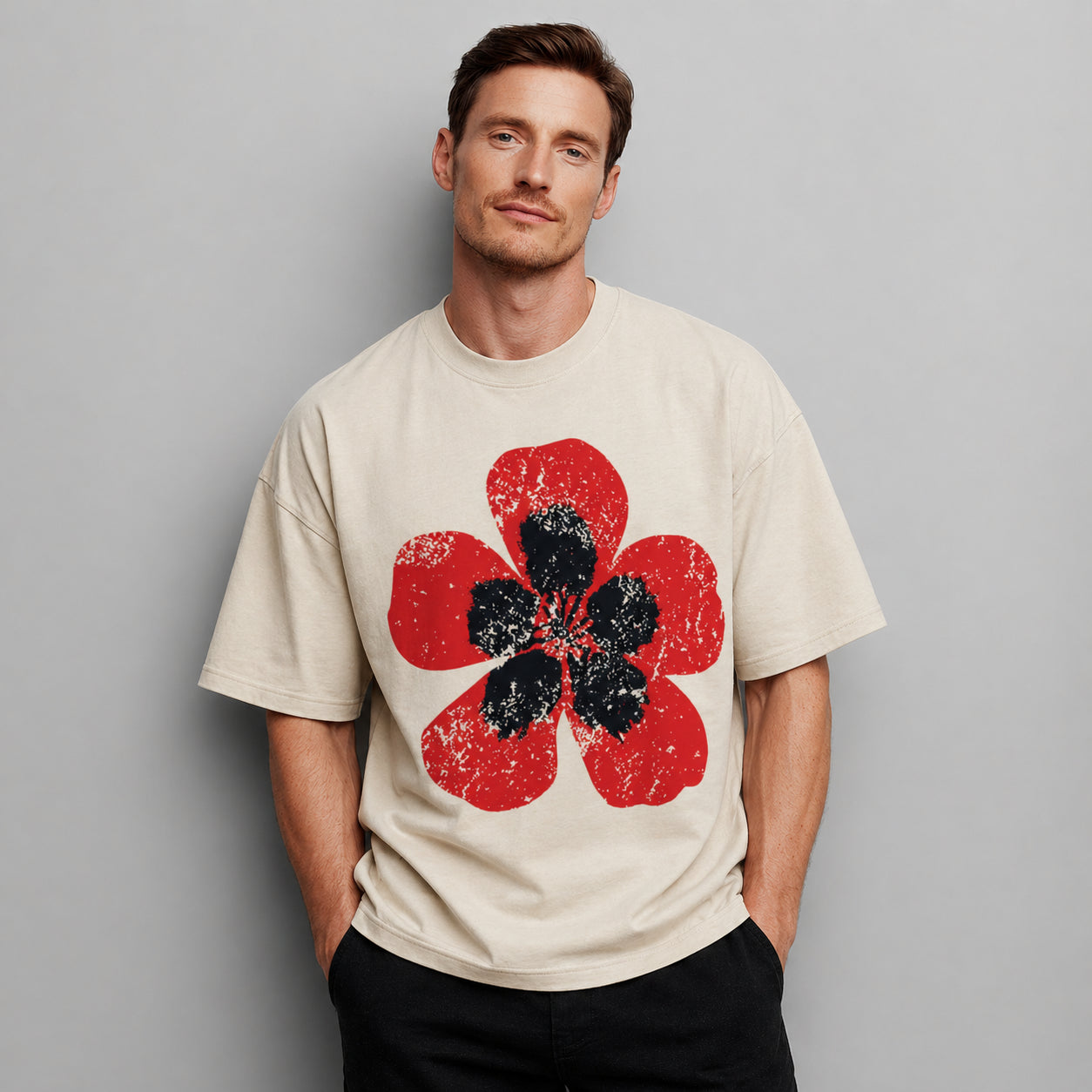 Man wearing a beige Poppy Bloom graphic t-shirt featuring floral artwork inspired by wildflowers, nature, and botanical beauty.