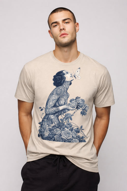 Man wearing a beigeBotanical Muse graphic t-shirt featuring botanical artwork inspired by wildflowers and vintage illustration