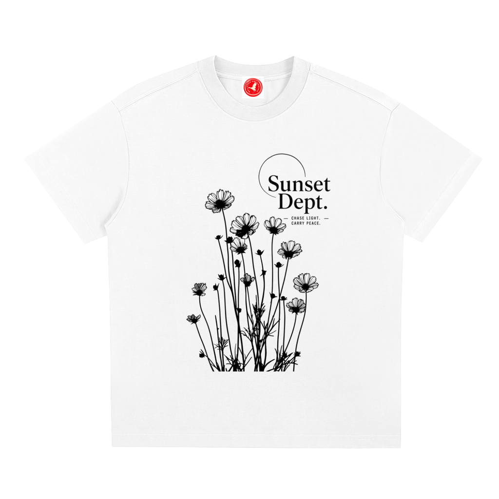 White Graphic t-shirt featuring sunset-inspired artwork celebrating relaxed coastal living and everyday adventure.