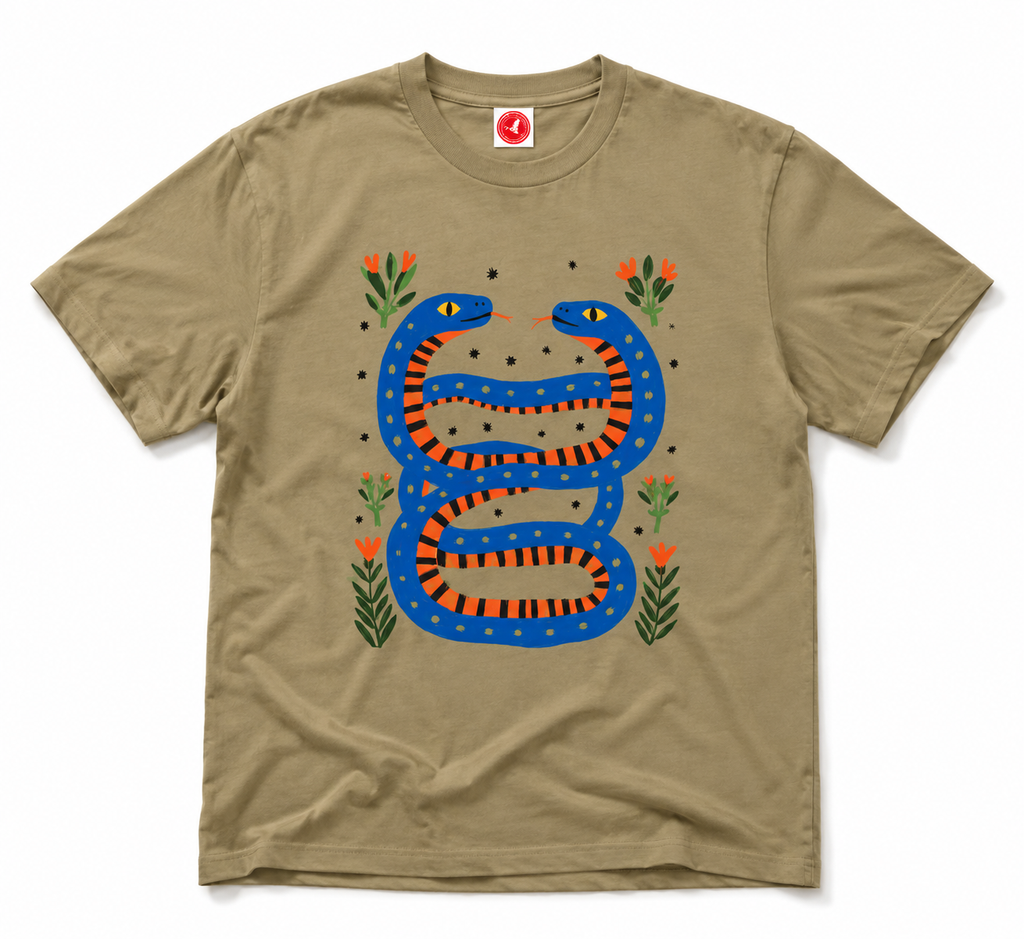 Twin Serpents boys graphic t-shirt featuring original blue and orange serpent artwork with floral accents. Soft cotton short-sleeve tee laid flat on a white background by Del Lago Greenwich.
